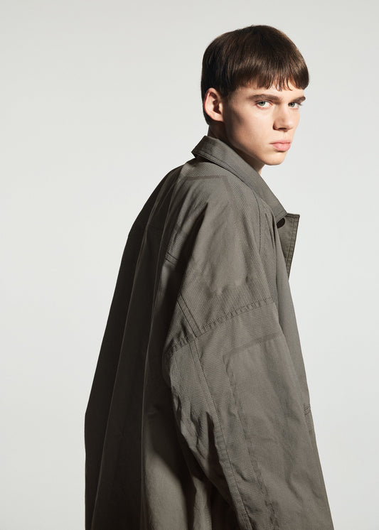 A model wears the A-POC ABLE ISSEY MIYAKE TYPE-U 001-1 coat.