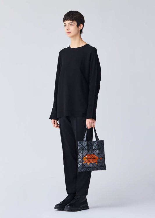 A model wears the Bao Bao Issey Miyake WONDER tote bag.
