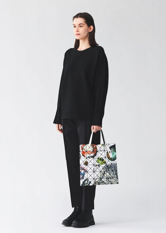 A model wears the BAO BAO ISSEY MIYAKE COSMIC tote bag.