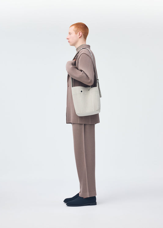 A model wears the Homme Plisse Issey Miyake UTILITY bag.
