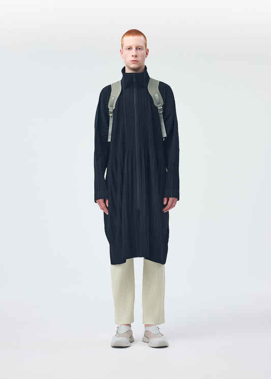 A model wears the Homme Plisse Issey Miyake MONTHLY COLORS : NOVEMBER coat.