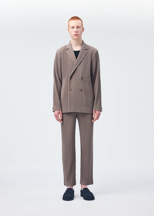 A model wears the Homme Plisse Issey Miyake TAILORED PLEATS 1 trousers.