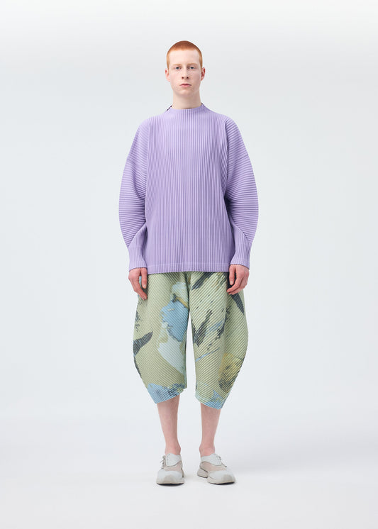 A model wears the Homme Plisse Issey Miyake PAINTED STONE trousers.