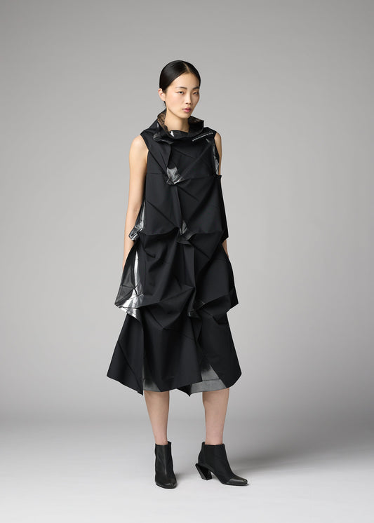 A model wears the 132 5. ISSEY MIYAKE No.1-1 no-10-ramie-dress-black-x-silver.