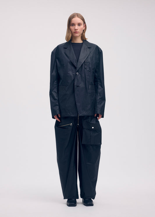 A model wears the Issey Miyake AERIAL STEEL jacket.