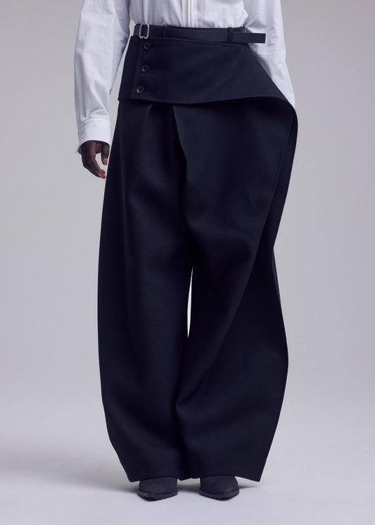 A model wears the ISSEY MIYAKE CALLIGRAPH trousers.
