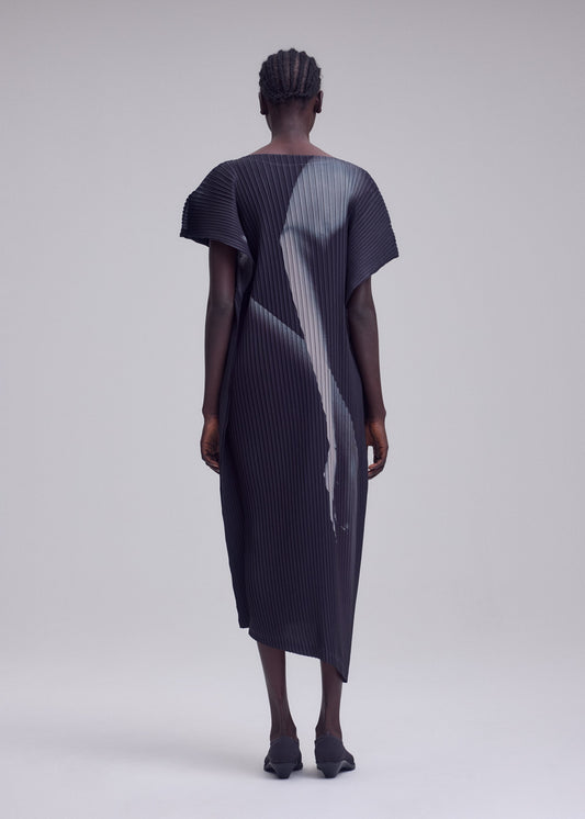 A model wears the ISSEY MIYAKE HANDS OF LOVER PLEATS dress.