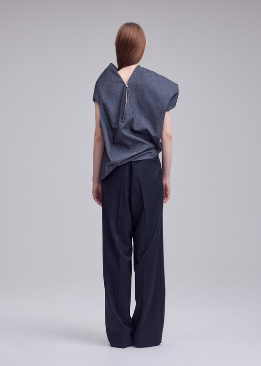 A model wears the ISSEY MIYAKE REFLECTION shirt.