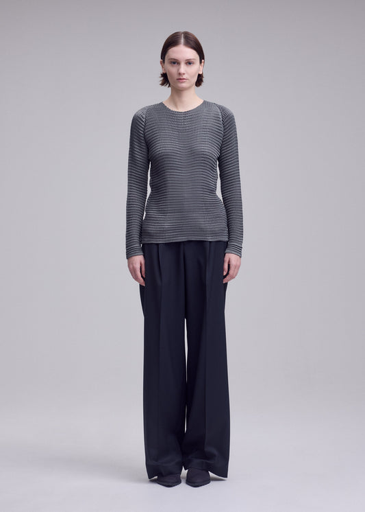 A model wears the ISSEY MIYAKE SUEDE LIKE PLEATS suede-like-pleats-shirt-light-pink.