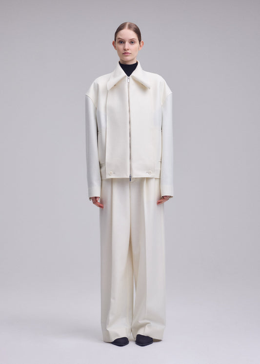 A model wears the ISSEY MIYAKE SHELL blouson.