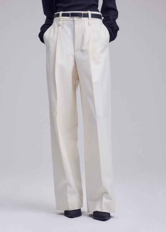 A model wears the ISSEY MIYAKE SHELL trousers.