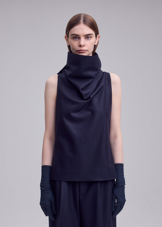 A model wears the ISSEY MIYAKE SHELL shirt.
