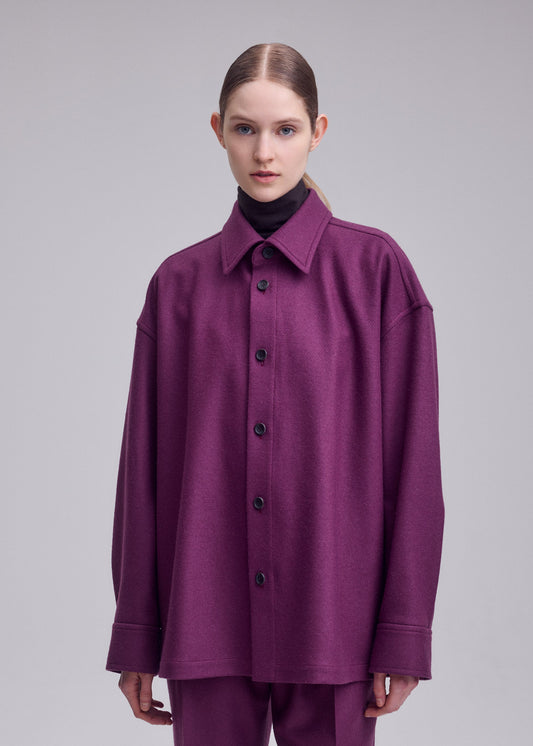 A model wears the ISSEY MIYAKE MANNER shirt.