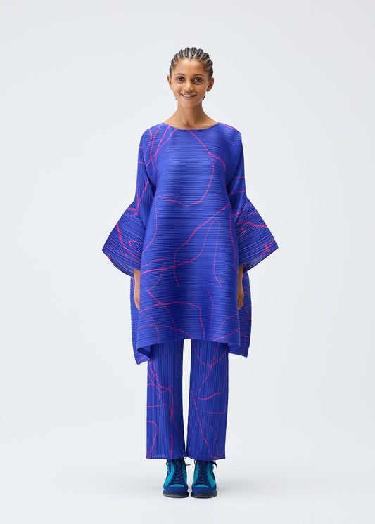A model wears the Pleats Please Issey Miyake PAUSE tunic.