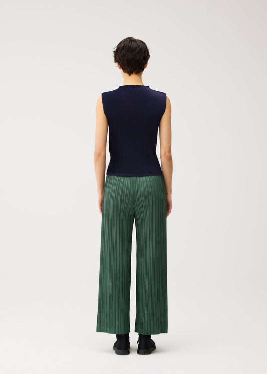 A model wears the PLEATS PLEASE ISSEY MIYAKE MIST SEPTEMBER shirt.