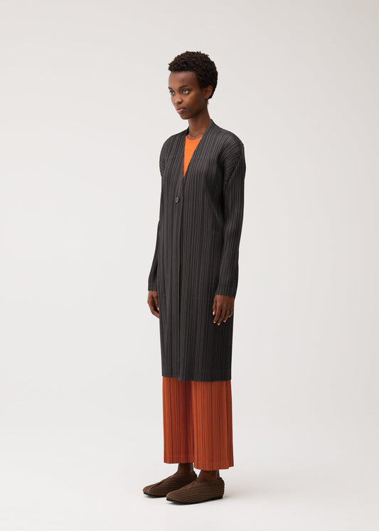 A model wears the PLEATS PLEASE ISSEY MIYAKE PLEATS JACKET coat.
