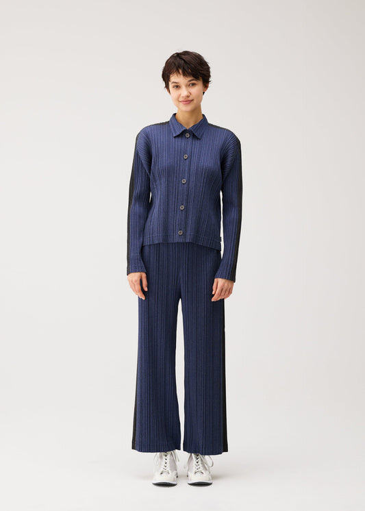 A model wears the PLEATS PLEASE ISSEY MIYAKE COTTON DENIM blouson.