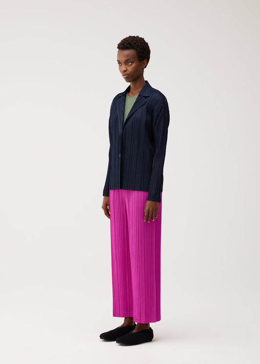 A model wears the PLEATS PLEASE ISSEY MIYAKE PLEATS JACKET jacket.