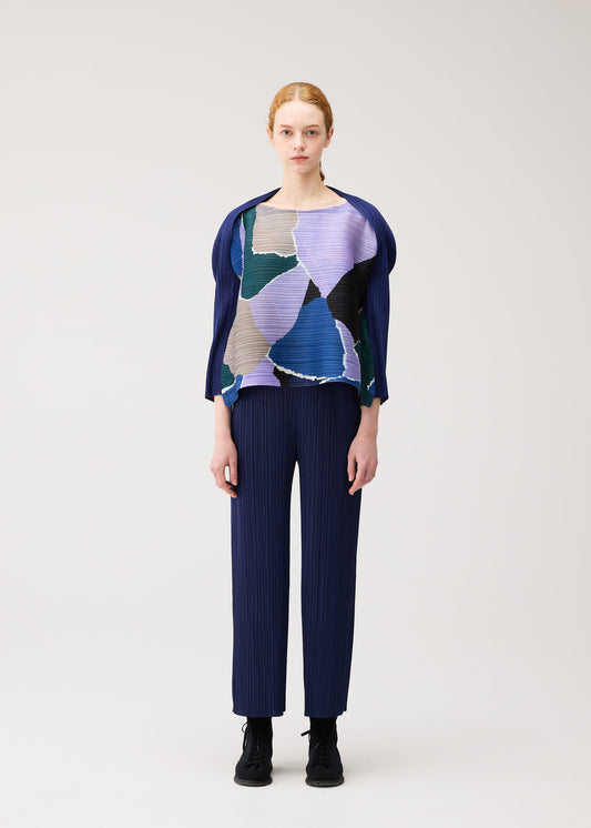 A model wears the PLEATS PLEASE ISSEY MIYAKE SURPRISE! shirt.