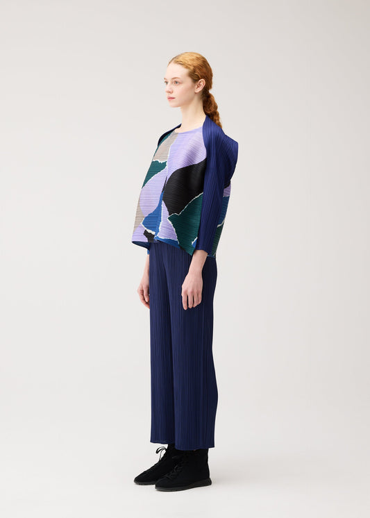 A model wears the PLEATS PLEASE ISSEY MIYAKE SURPRISE! shirt.