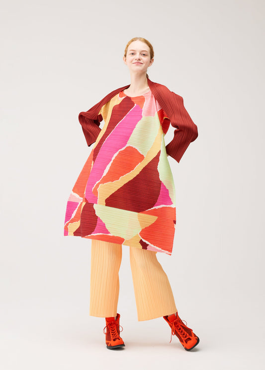 A model wears the PLEATS PLEASE ISSEY MIYAKE SURPRISE! dress.