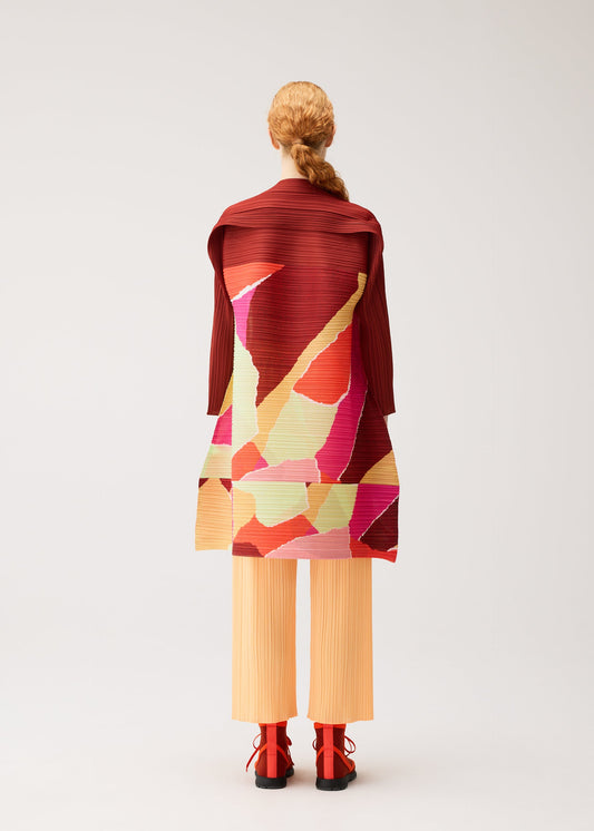 A model wears the PLEATS PLEASE ISSEY MIYAKE SURPRISE! dress.