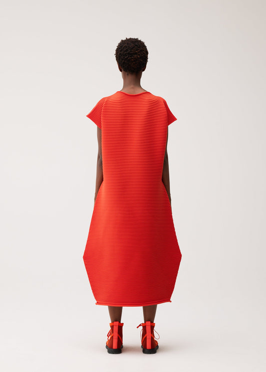 A model wears the PLEATS PLEASE ISSEY MIYAKE ZIG ZAG KNIT dress.