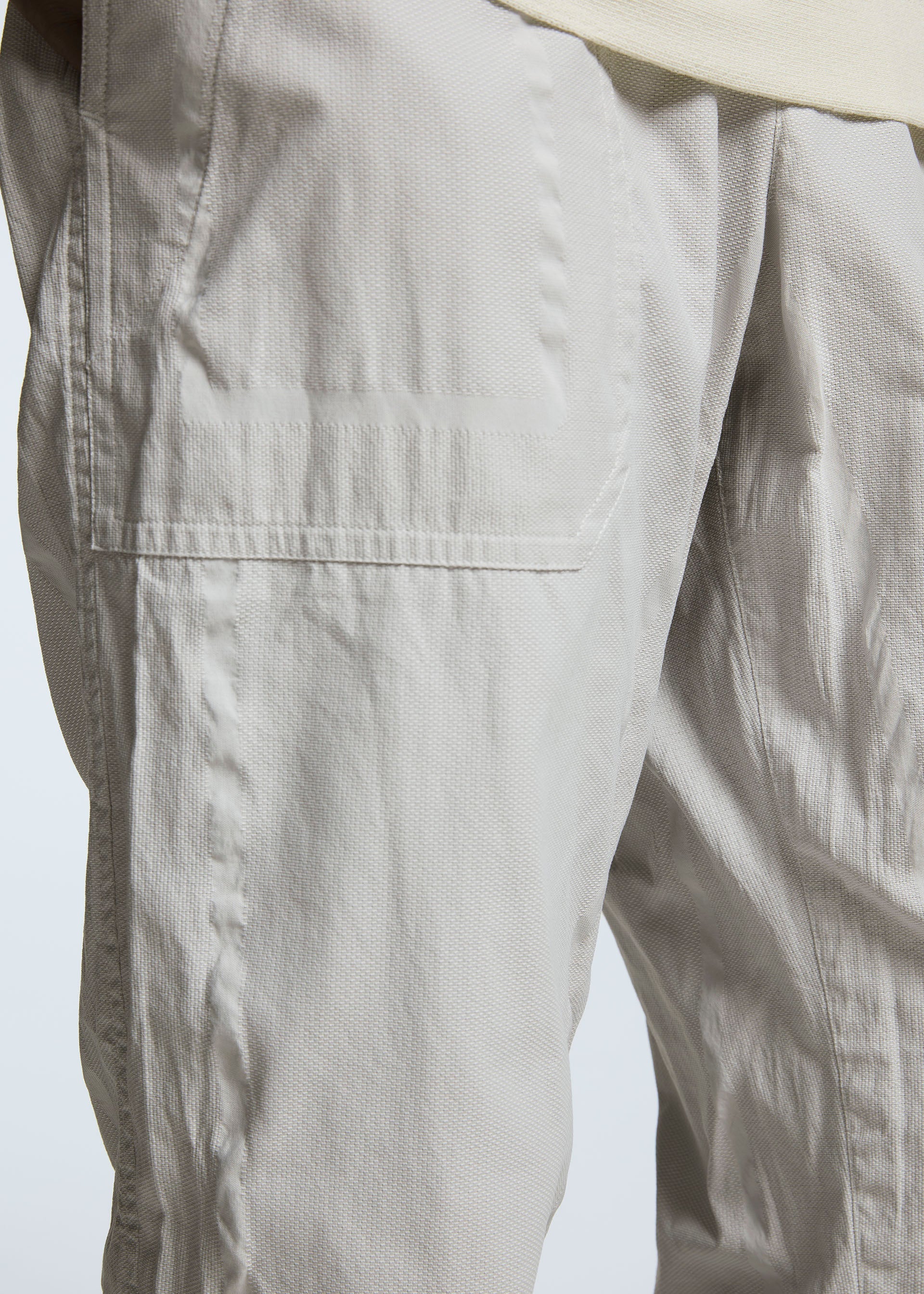 A model wears the A-POC ABLE ISSEY MIYAKE TYPE U 001 trousers.