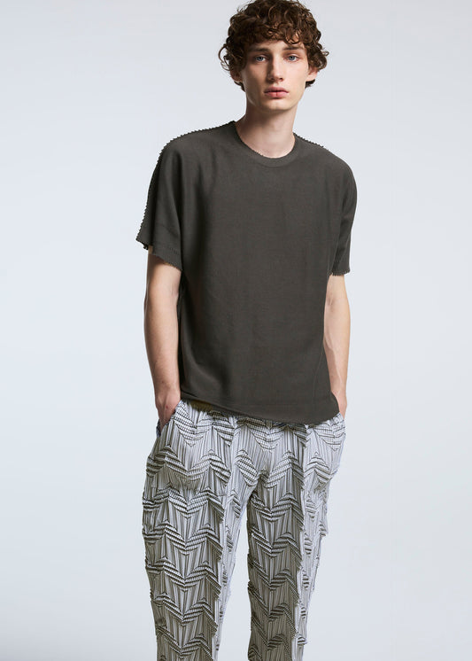 A model wears the A-POC ABLE ISSEY MIYAKE TYPE O 019 trousers.