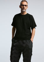 A model wears the A-POC ABLE ISSEY MIYAKE TYPE O 019 trousers.