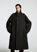 A model wears the A-Poc Able Issey Miyake TYPE O 011 coat.