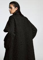 A model wears the A-Poc Able Issey Miyake TYPE O 011 coat.