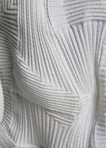 A model wears the A-Poc Able Issey Miyake TYPE O 020 trousers.