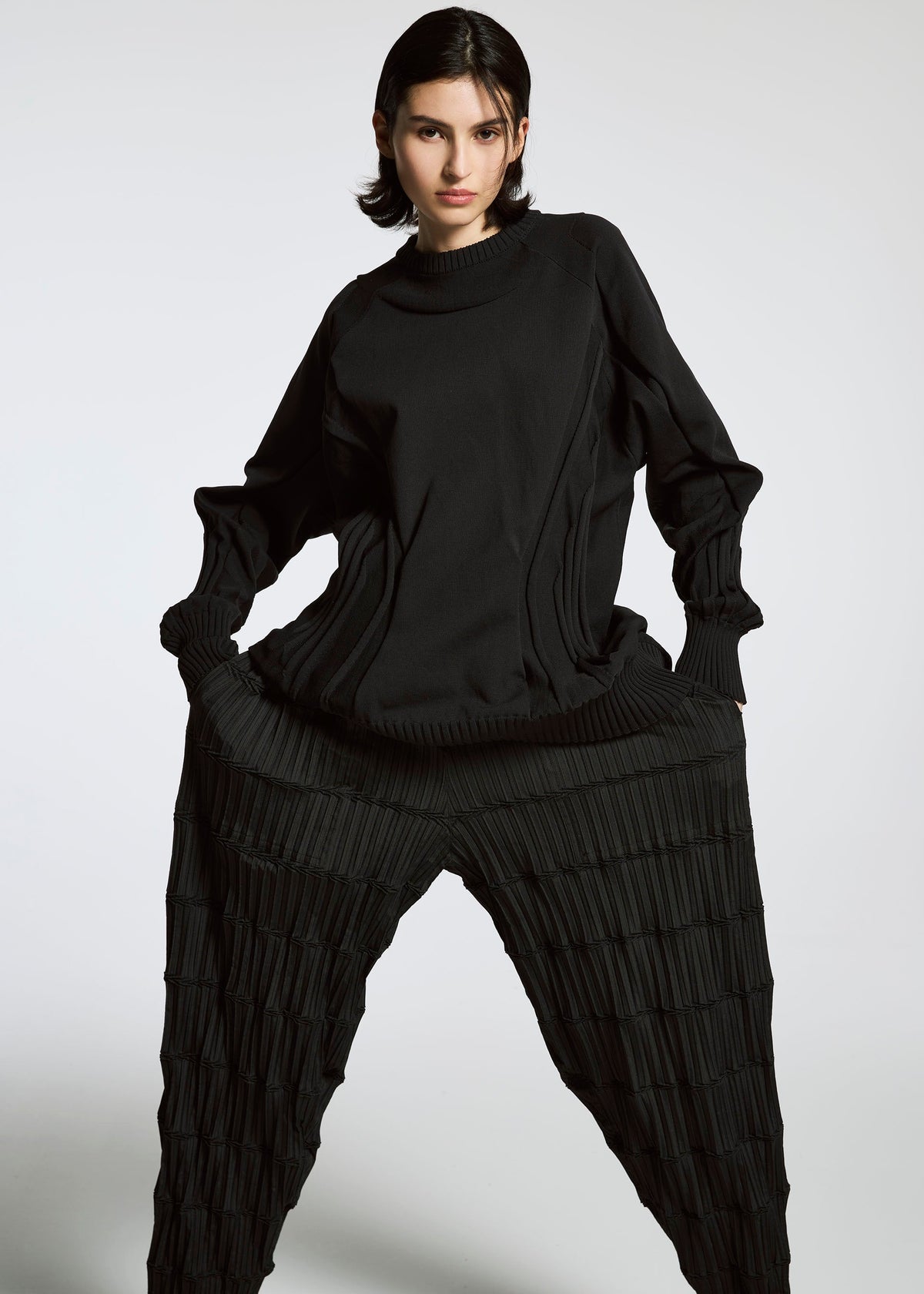 A model wears the A-Poc Able Issey Miyake TYPE O 015 trousers.