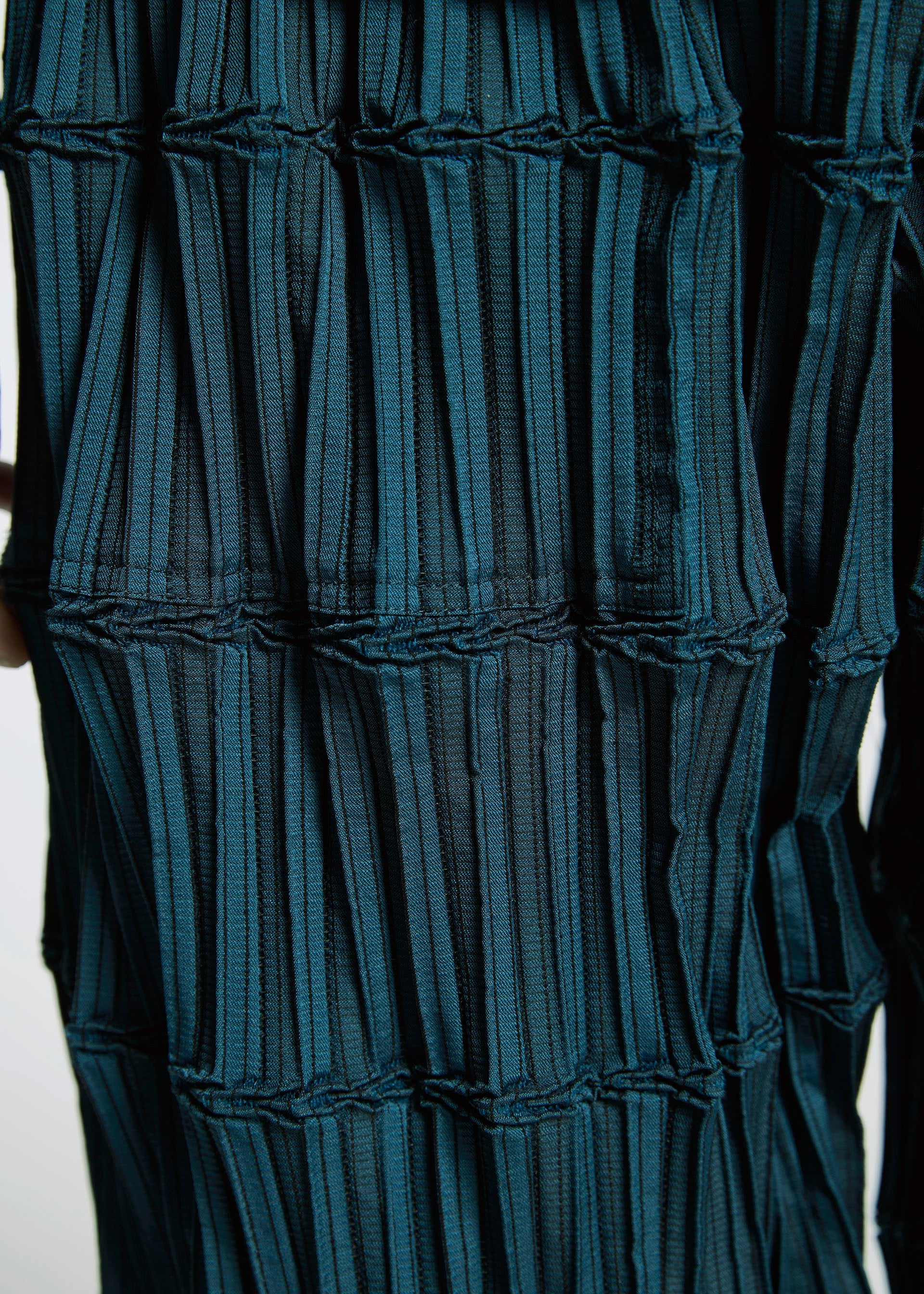 A model wears the A-Poc Able Issey Miyake TYPE O 015 trousers.