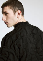 A model wears the APOCABLE TYPE K 007 prêt à porter.