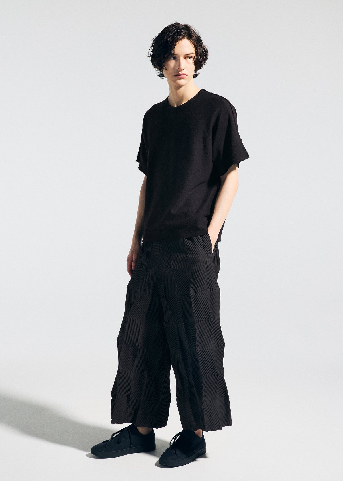 A model wears the A-Poc Able Issey Miyake TYPE W 009 1 pants.