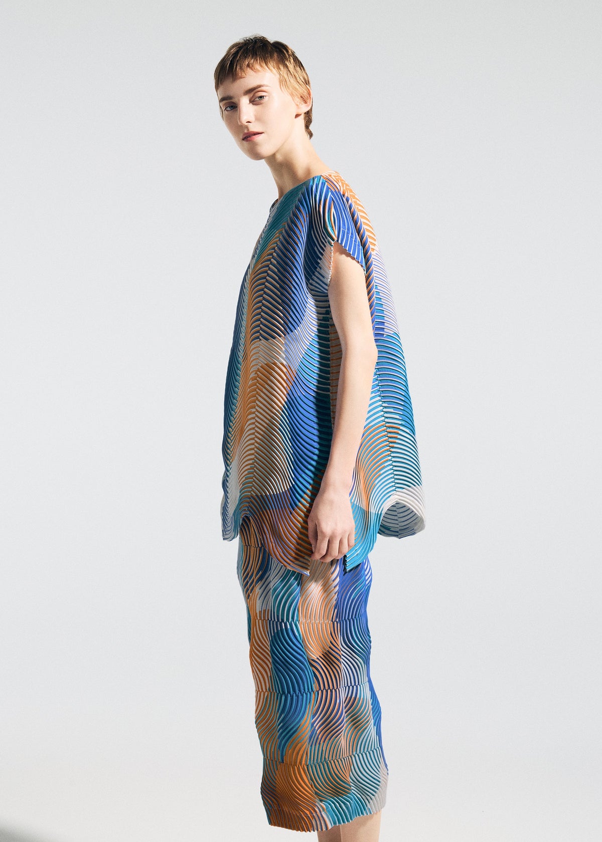 A model wears the A-POC ABLE ISSEY MIYAKE TYPE-P 005 type-p-005-shirt-pink-hued.