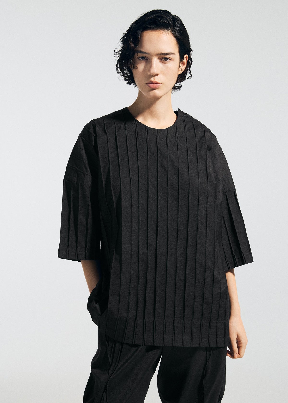 A model wears the A-Poc Able Issey Miyake TYPE W 007 shirt.