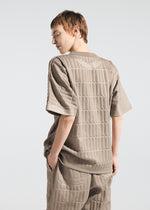 A model wears the A-Poc Able Issey Miyake TYPE E 001 pants.