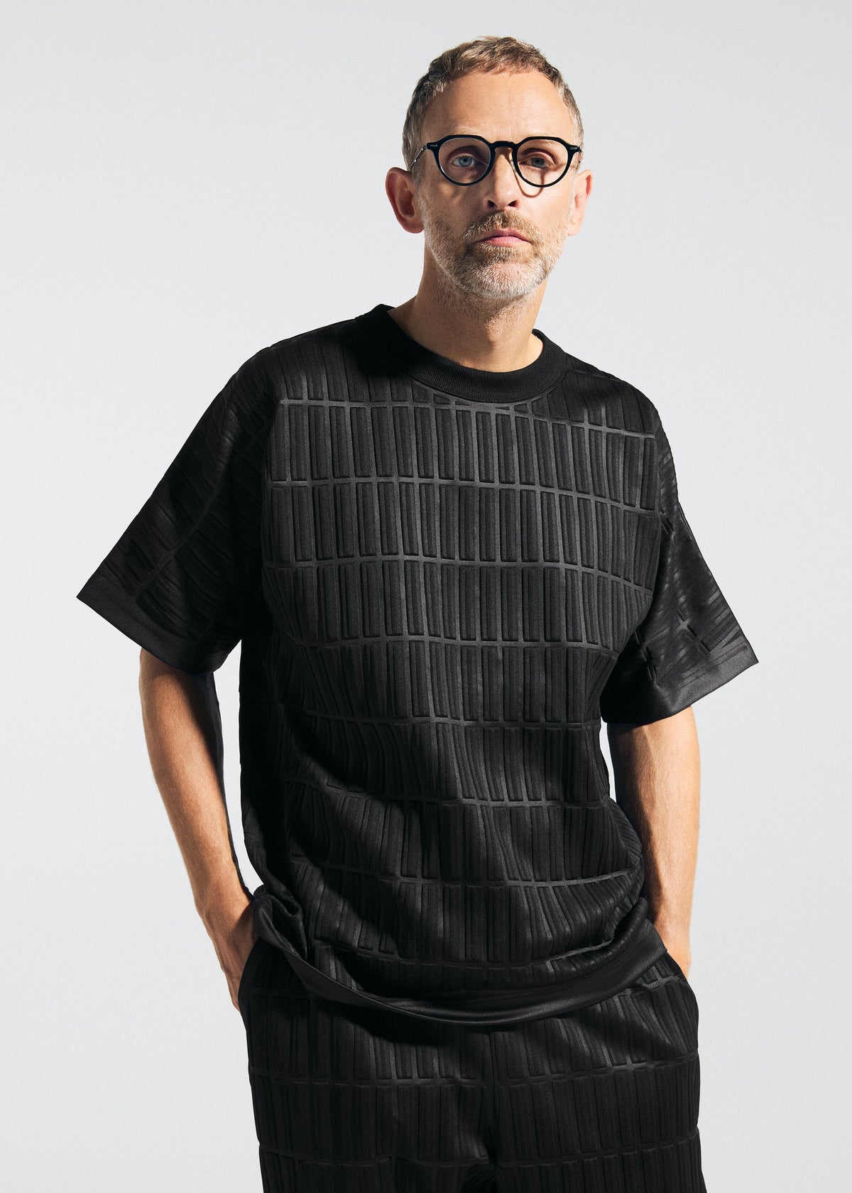 A model wears the A-Poc Able Issey Miyake TYPE E 001 shirt.
