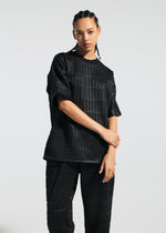A model wears the A-Poc Able Issey Miyake TYPE E 001 shirt.