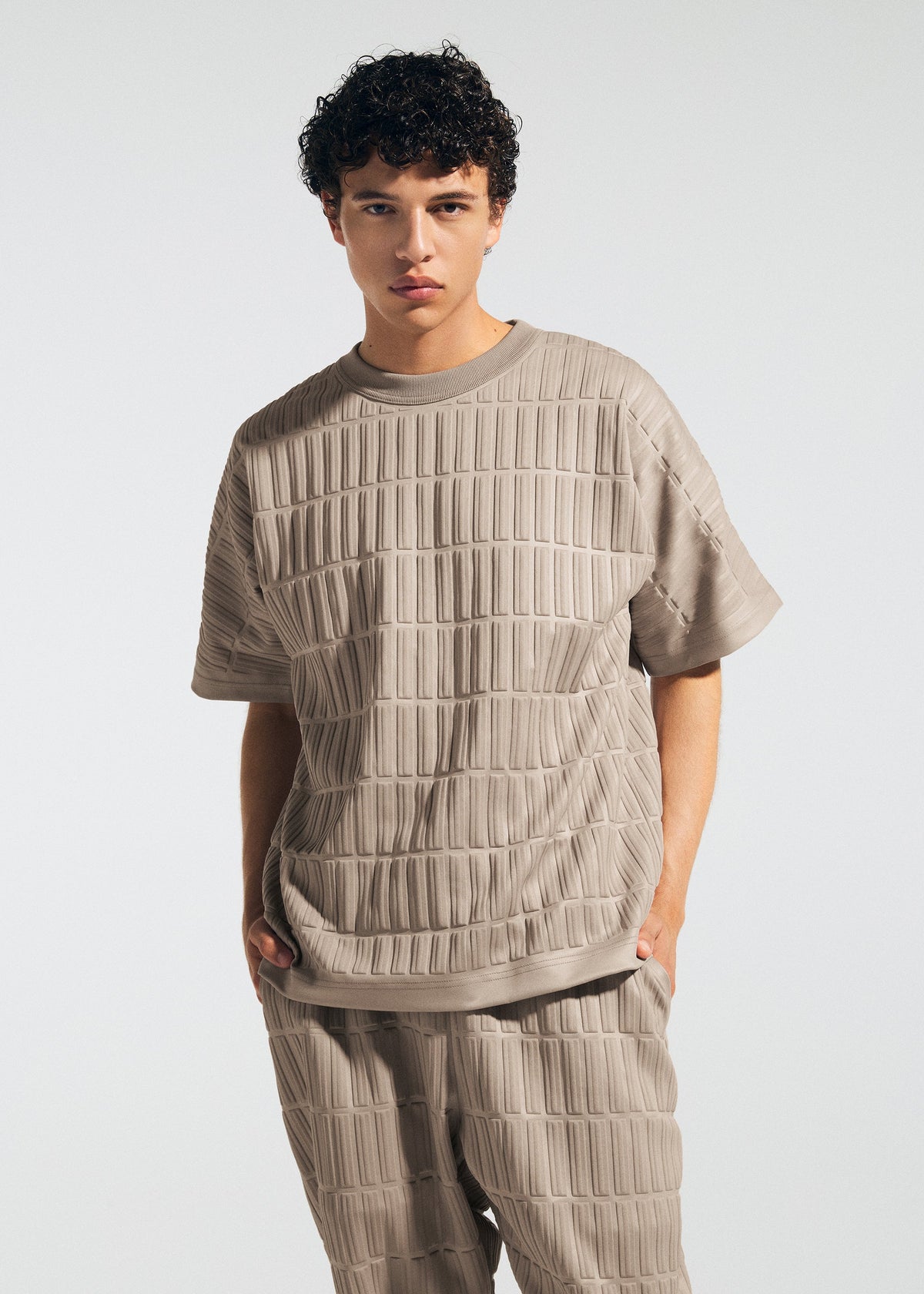 A model wears the A-Poc Able Issey Miyake TYPE E 001 shirt.