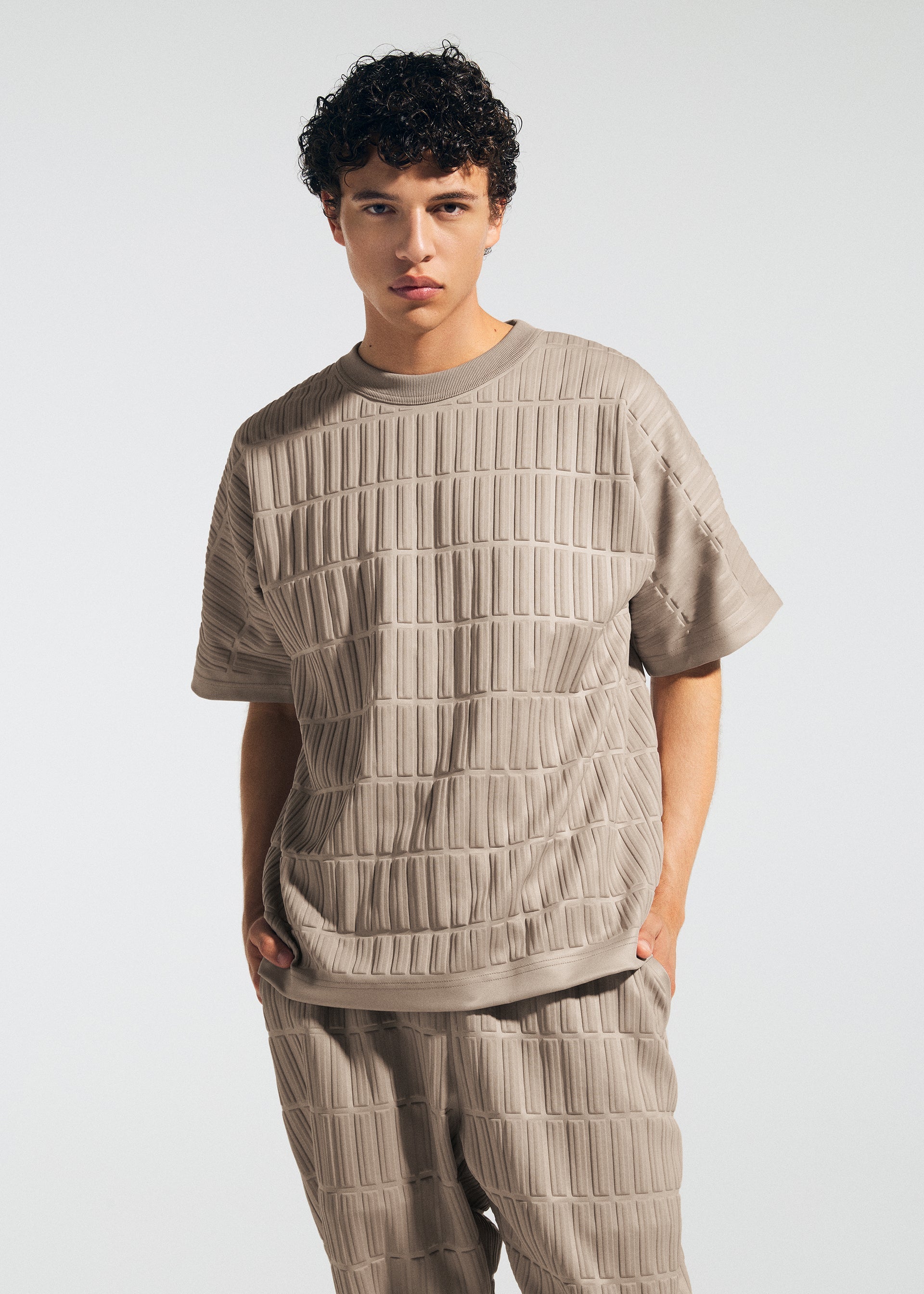 A model wears the A-Poc Able Issey Miyake TYPE E 001 shirt.