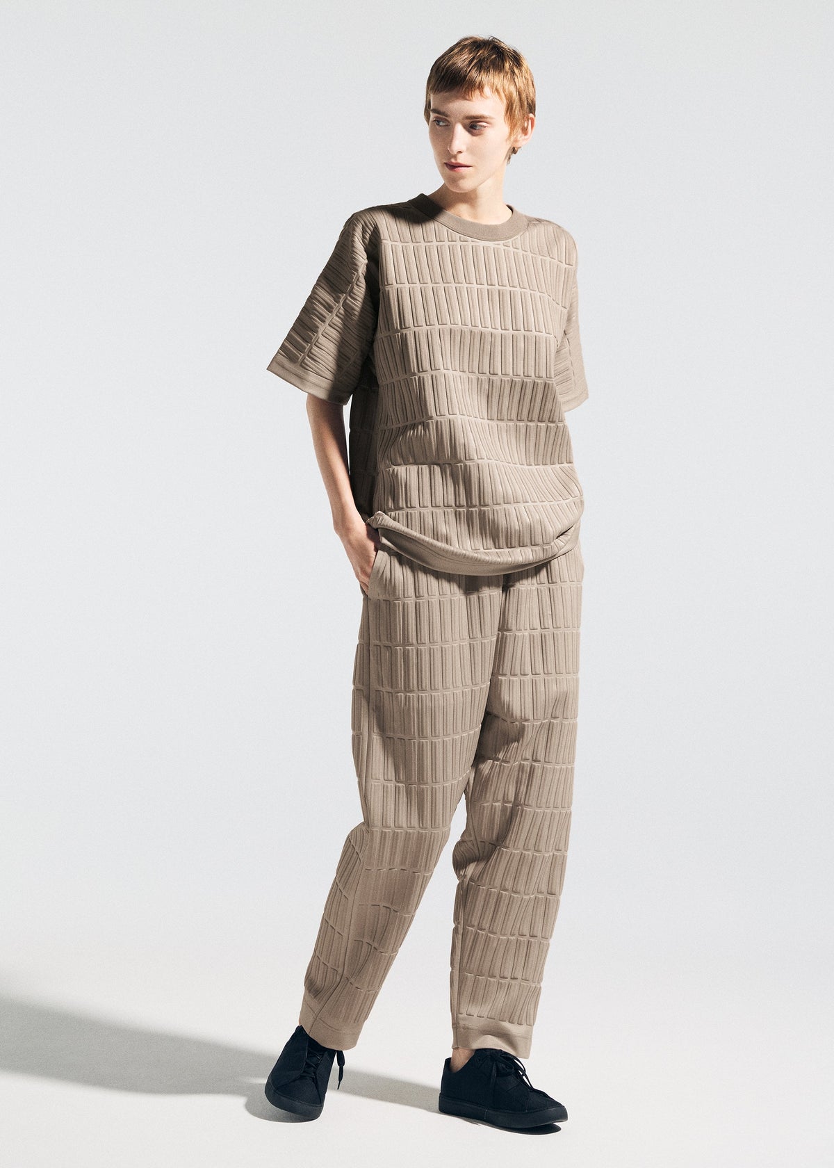 A model wears the A-Poc Able Issey Miyake TYPE E 001 shirt.