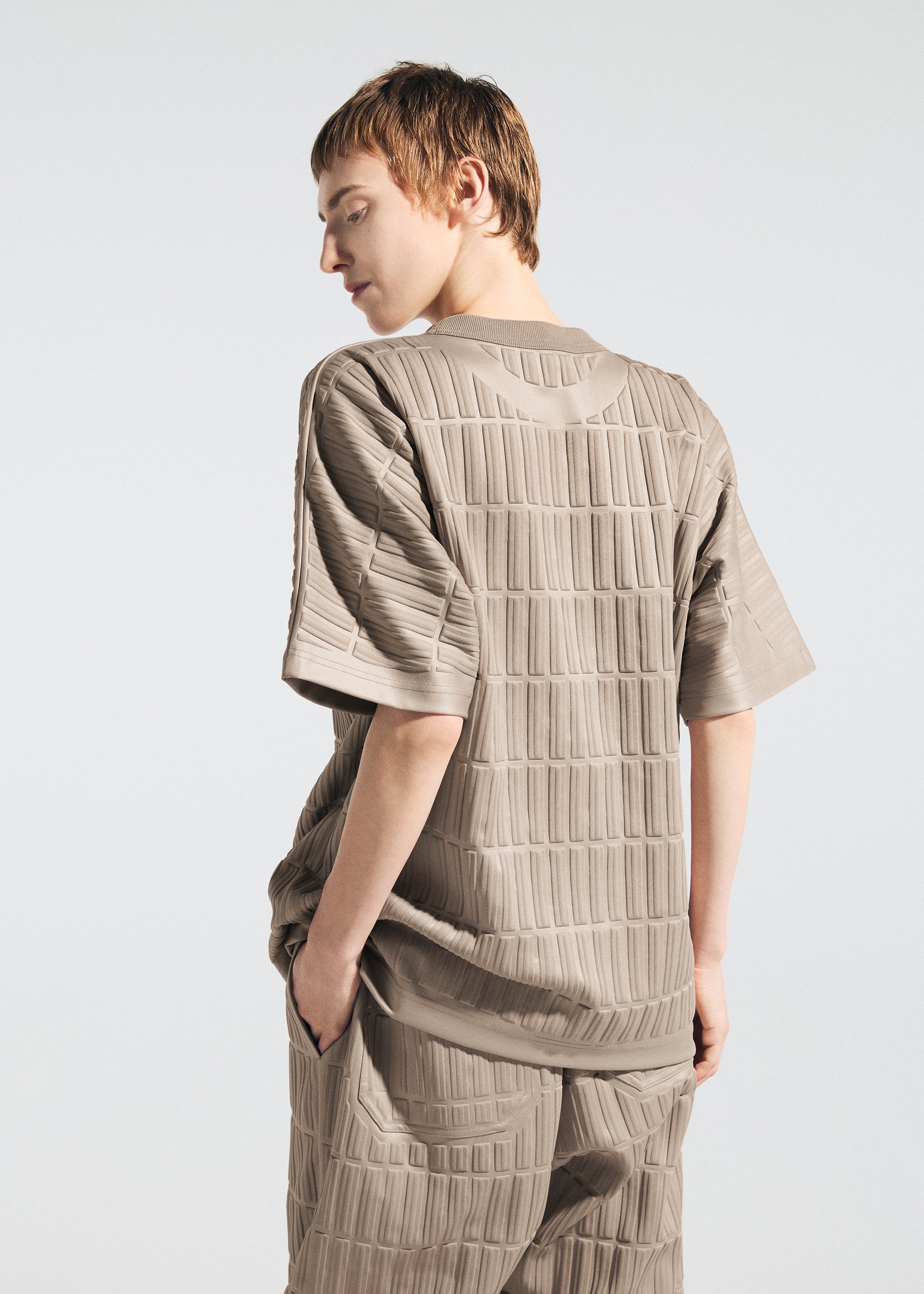 A model wears the A-Poc Able Issey Miyake TYPE E 001 shirt.