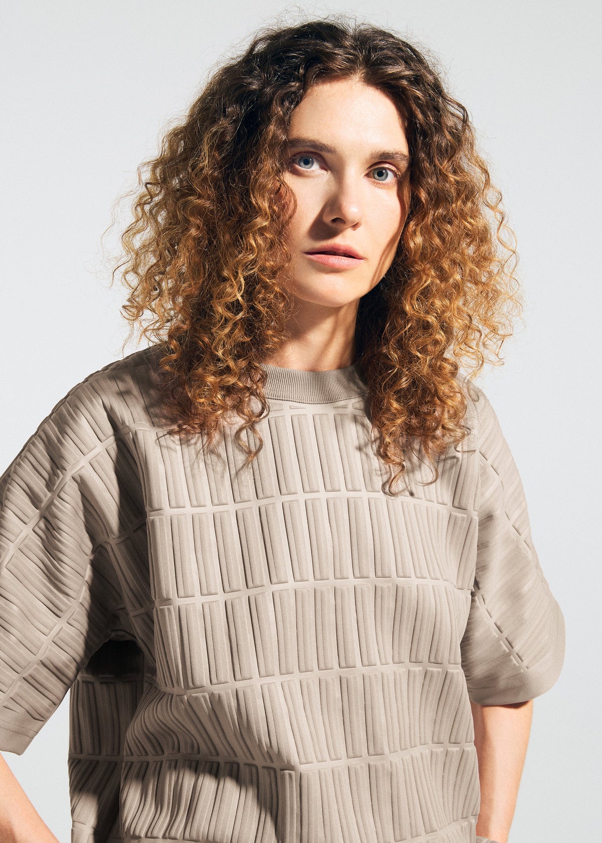 A model wears the A-Poc Able Issey Miyake TYPE E 001 shirt.