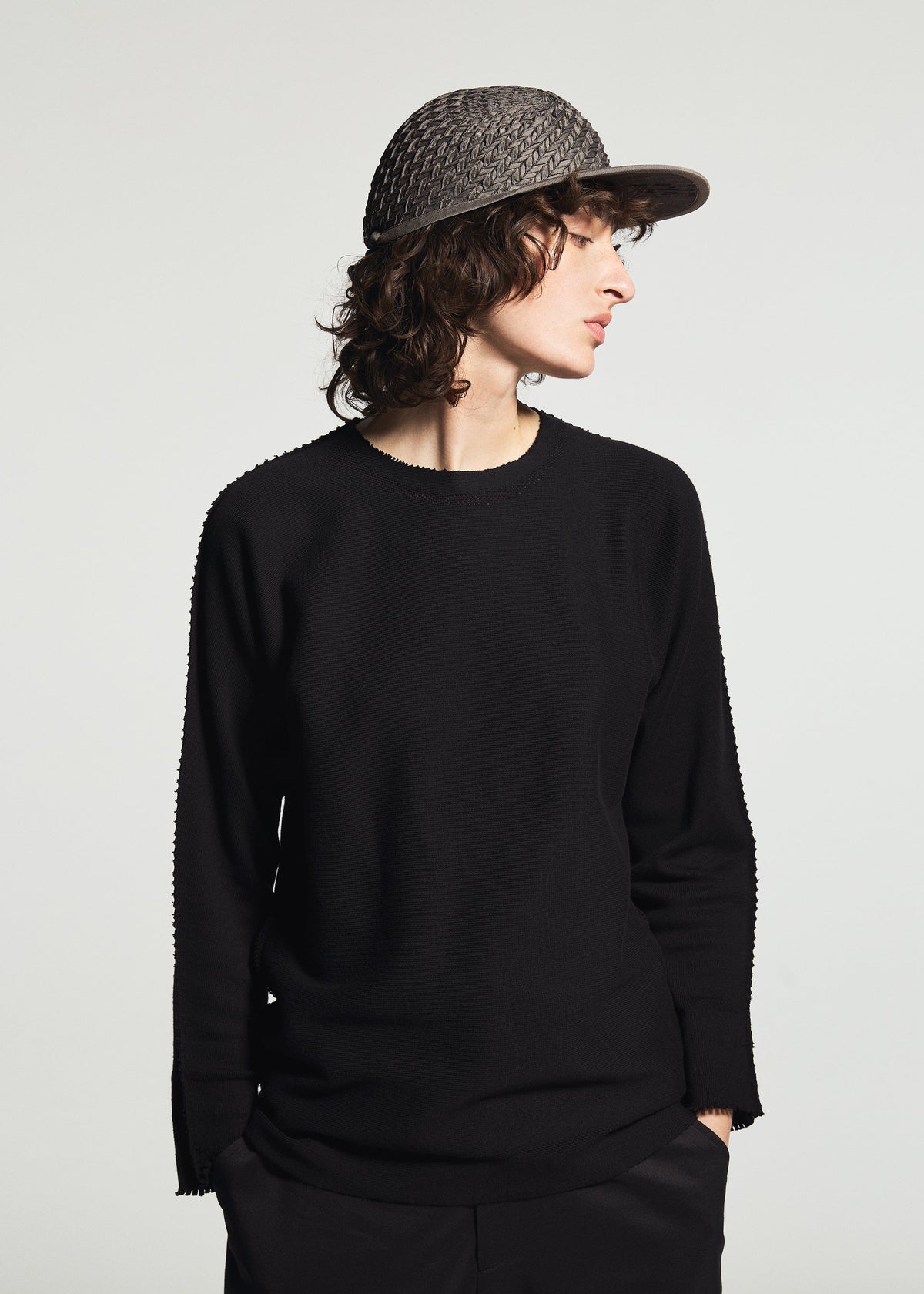 A model wears the A-POC ABLE ISSEY MIYAKE TYPE-O CAP cap.