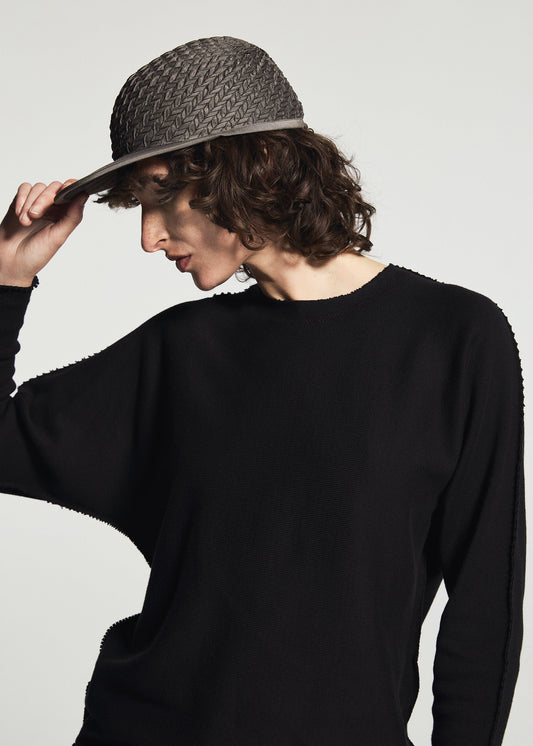A model wears the A-POC ABLE ISSEY MIYAKE TYPE-O CAP cap.
