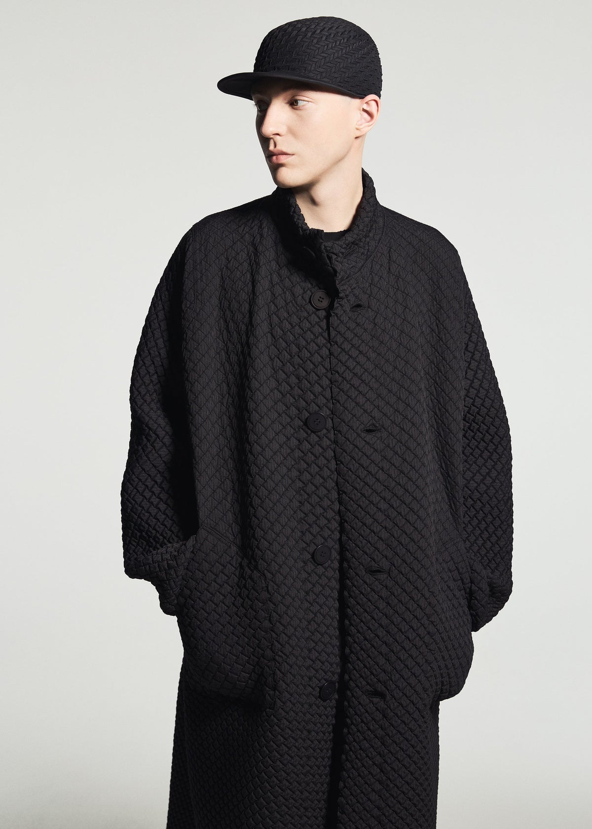 A model wears the A-POC ABLE ISSEY MIYAKE TYPE-O CAP cap.